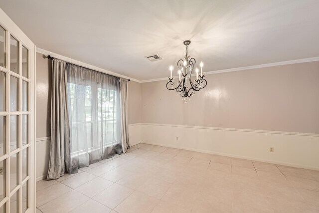 empty room with a notable chandelier, light tile patterned floors, and crown molding