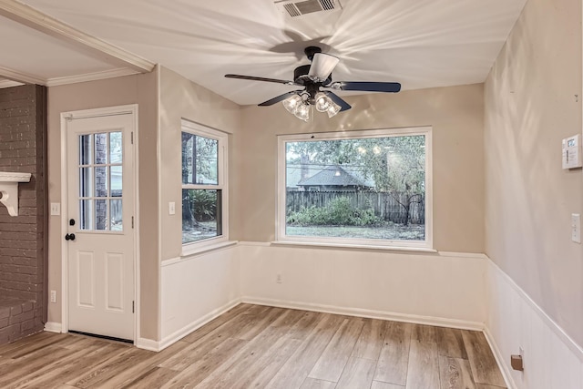 interior space featuring light hardwood / wood-style floors, ceiling fan, and ornamental molding