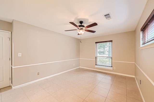 spare room featuring ceiling fan and light tile patterned floors