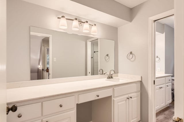 bathroom with vanity and wood-type flooring