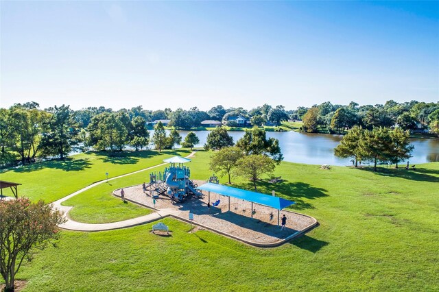 surrounding community with a playground, a yard, and a water view