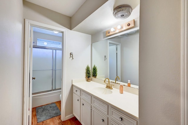 bathroom featuring toilet, vanity, and hardwood / wood-style flooring