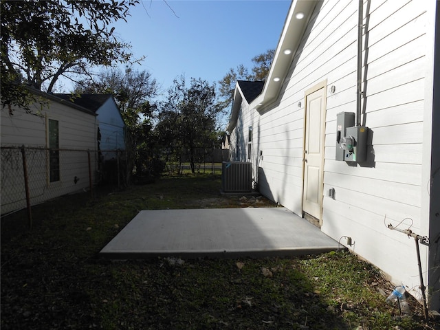 view of yard featuring central air condition unit and a patio