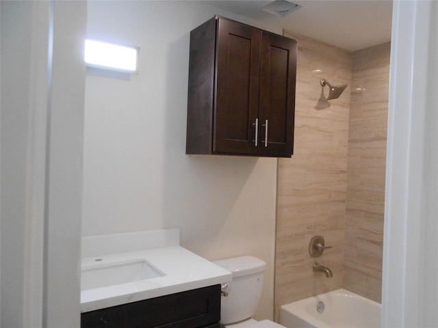 full bathroom with vanity, tiled shower / bath combo, and toilet