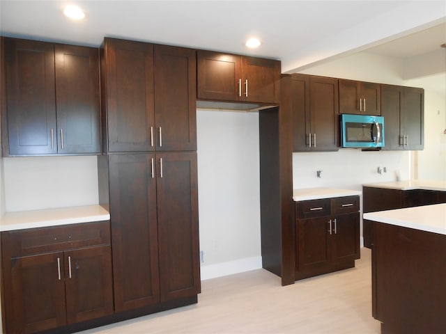 kitchen featuring dark brown cabinets