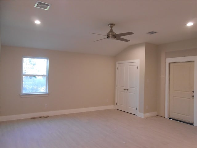 empty room featuring light wood-type flooring, ceiling fan, and lofted ceiling