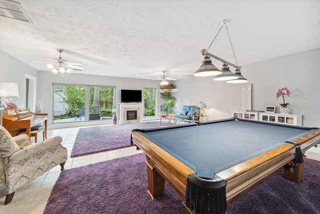 game room featuring ceiling fan, light tile patterned flooring, a textured ceiling, and billiards