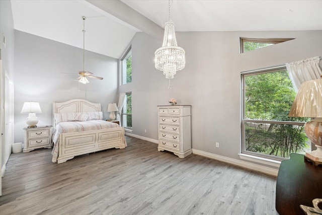 bedroom with wood-type flooring, lofted ceiling with beams, and an inviting chandelier