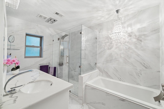 bathroom with a chandelier, vanity, and independent shower and bath