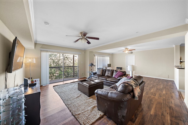 living room with ceiling fan, dark hardwood / wood-style flooring, and ornamental molding