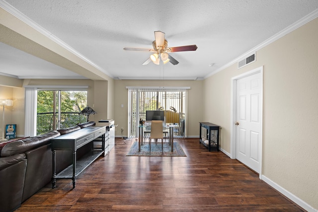 dining space featuring a textured ceiling, dark wood-type flooring, ceiling fan, and crown molding