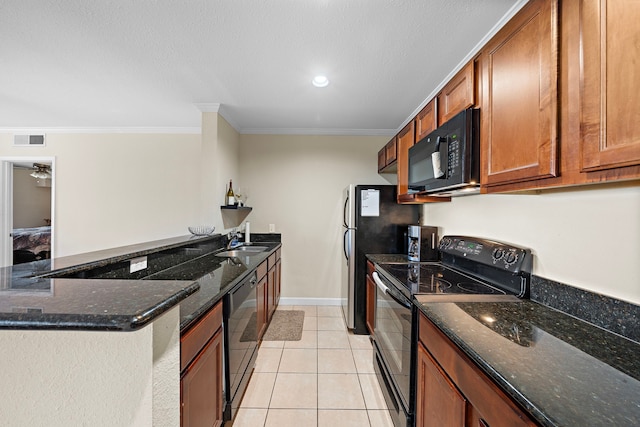 kitchen with ornamental molding, dark stone counters, sink, black appliances, and light tile patterned floors