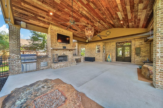 view of patio / terrace featuring grilling area, ceiling fan, an outdoor kitchen, and an outdoor brick fireplace