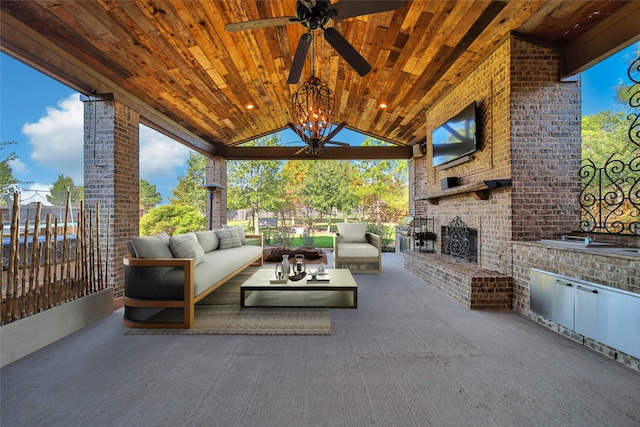 view of patio / terrace featuring an outdoor living space with a fireplace and ceiling fan