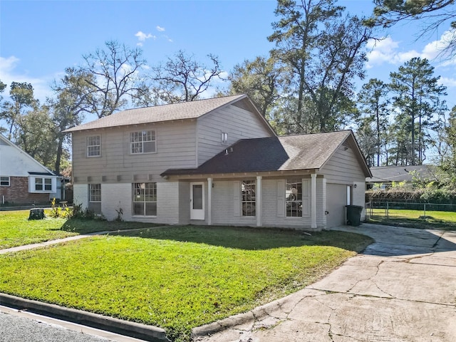 view of front property featuring a front yard and a garage