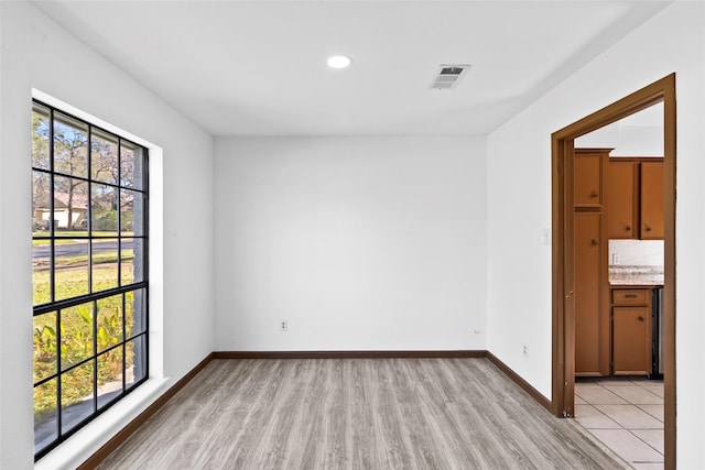 unfurnished room with light hardwood / wood-style floors