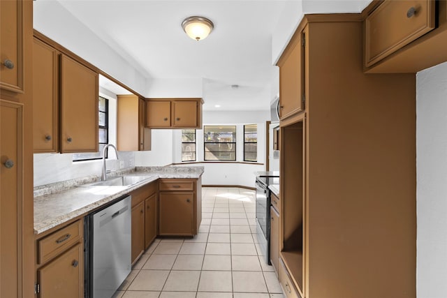 kitchen featuring kitchen peninsula, light tile patterned floors, stainless steel appliances, and sink