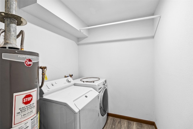 washroom featuring washer and dryer, dark hardwood / wood-style flooring, and gas water heater