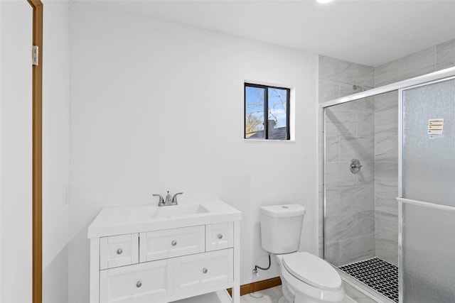 bathroom featuring vanity, toilet, and walk in shower