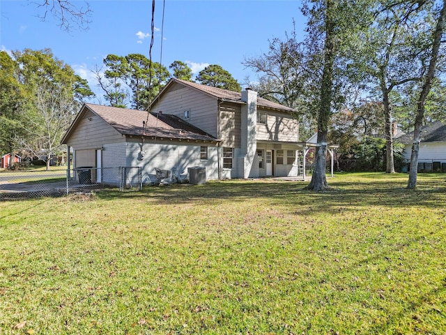 rear view of property with a yard and central AC