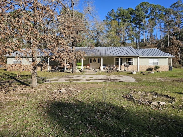 back of property featuring a yard and a patio