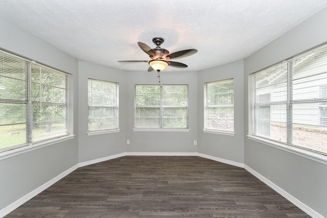 unfurnished sunroom with a wealth of natural light and ceiling fan