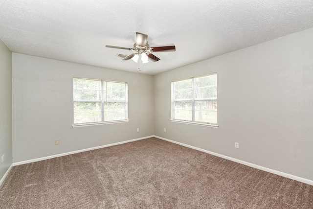 empty room featuring ceiling fan, carpet, and a textured ceiling