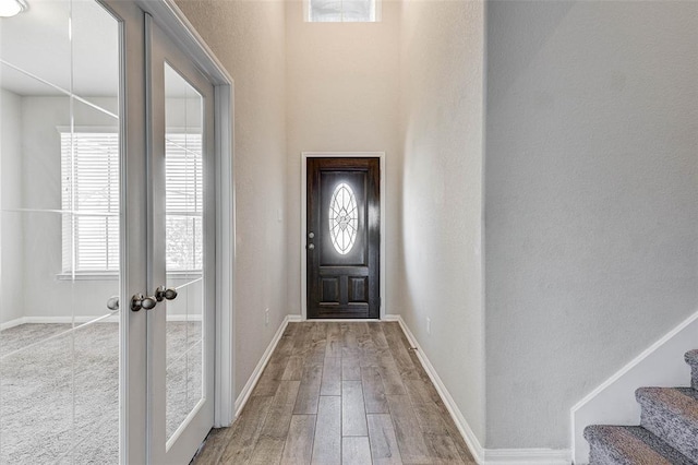 foyer featuring light hardwood / wood-style floors and french doors