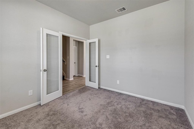 unfurnished bedroom featuring carpet flooring and french doors