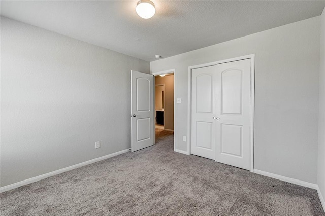 unfurnished bedroom featuring carpet and a closet