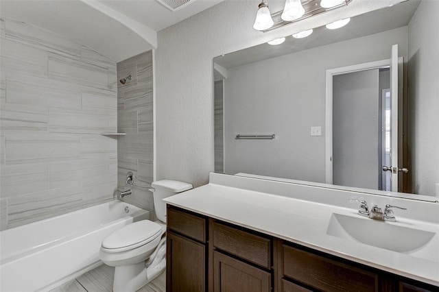 full bathroom with vanity, toilet, and tiled shower / bath