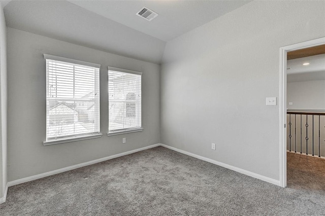 unfurnished room featuring carpet flooring and lofted ceiling