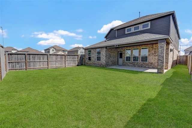 rear view of property with a yard and a patio