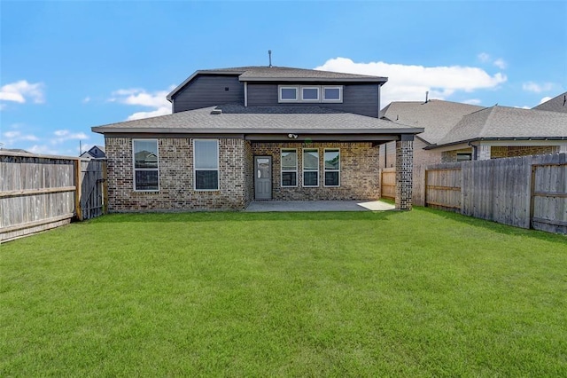 rear view of property featuring a patio area and a lawn