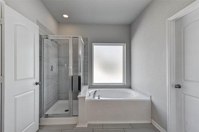 bathroom featuring independent shower and bath