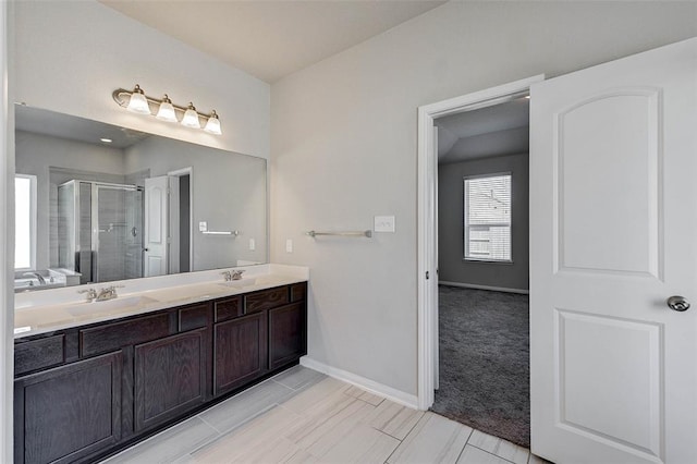 bathroom with vanity and a shower with shower door