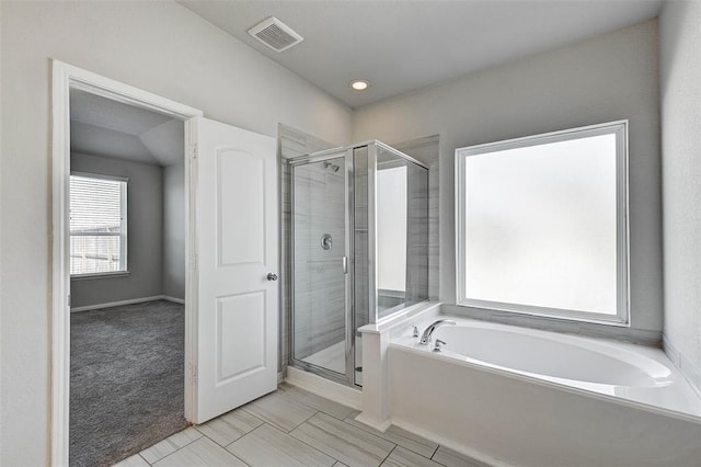 bathroom featuring separate shower and tub