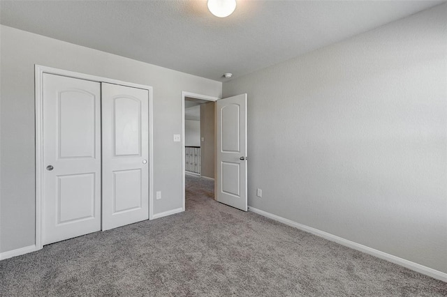 unfurnished bedroom featuring carpet flooring and a closet