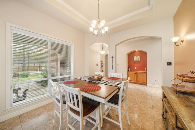 dining room with a raised ceiling, light tile patterned floors, and an inviting chandelier