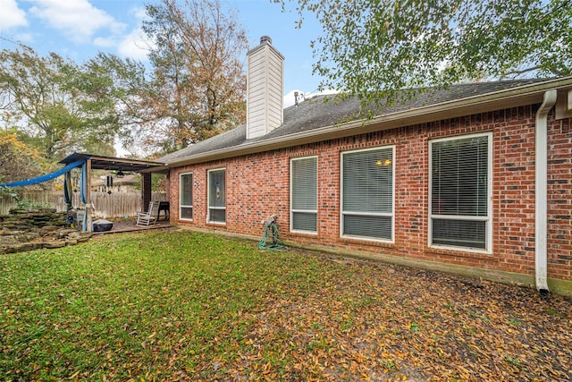 back of house featuring a yard