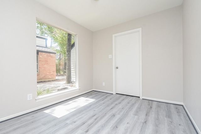 unfurnished room with light hardwood / wood-style floors