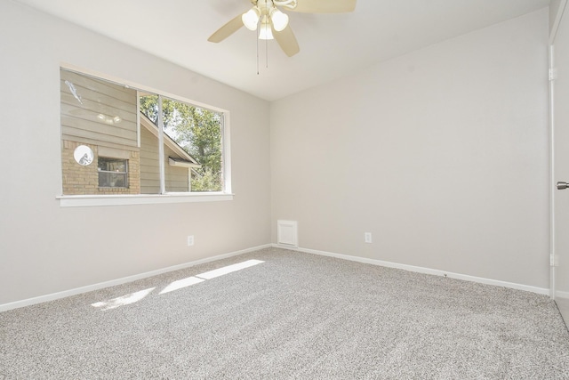 carpeted spare room featuring ceiling fan