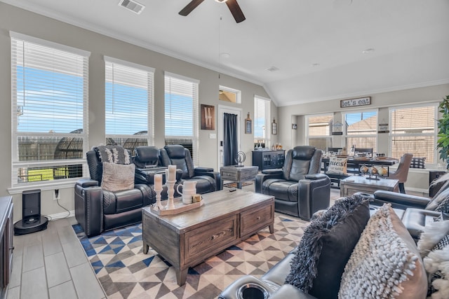 living room with ceiling fan, crown molding, and vaulted ceiling