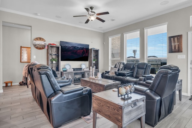 living room featuring ceiling fan, ornamental molding, and a fireplace