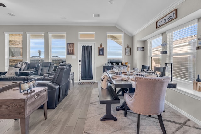 dining room featuring lofted ceiling and ornamental molding