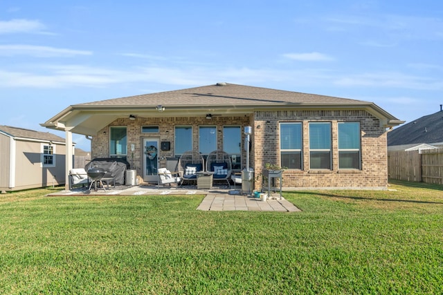 back of house with a lawn and a patio area