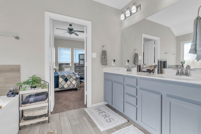 bathroom with ceiling fan, crown molding, and vanity