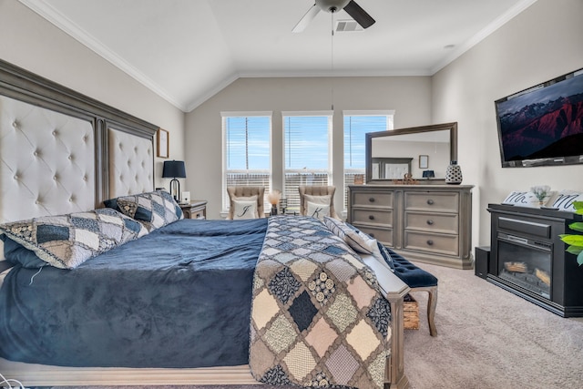 carpeted bedroom featuring ceiling fan, lofted ceiling, and ornamental molding