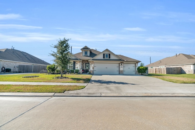 view of front of house featuring a front lawn and a garage