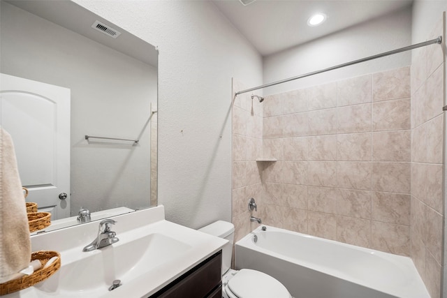 full bathroom featuring vanity, toilet, and tiled shower / bath